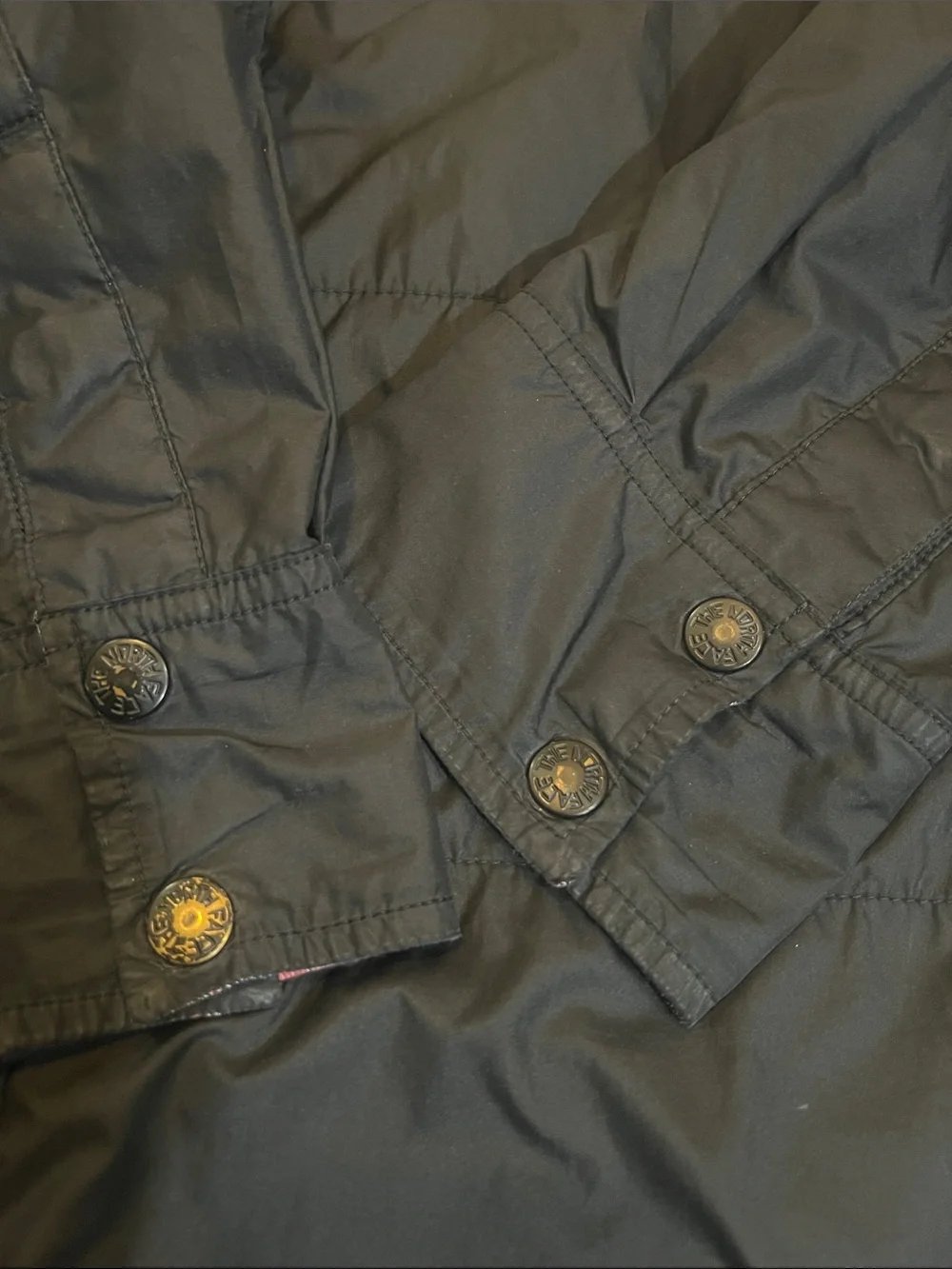 The North Face Black Jacket with Red & Blue Plaid Lining can be worn inside-out